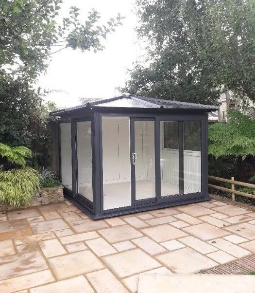 Anthracite compact garden room on a patio